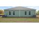 View of the backyard featuring a well-maintained lawn, neutral siding, and an outdoor AC unit at 119 Mims Academy Dr, Harleyville, SC 29448