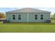View of the backyard featuring a well-maintained lawn, neutral siding, and an outdoor AC unit at 119 Mims Academy Dr, Harleyville, SC 29448