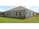 View of the backyard featuring a well-maintained lawn, neutral siding, and an outdoor AC unit at 119 Mims Academy Dr, Harleyville, SC 29448