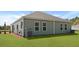 View of the backyard featuring a well-maintained lawn, neutral siding, and an outdoor AC unit at 119 Mims Academy Dr, Harleyville, SC 29448