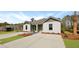 Beautiful exterior view of a modern duplex with lush landscaping and ample parking space at 119 Mims Academy Dr, Harleyville, SC 29448