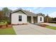 Inviting duplex exterior showcasing a spacious driveway and tastefully landscaped grounds at 119 Mims Academy Dr, Harleyville, SC 29448
