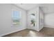 Bright living room featuring wood-look flooring, a window with blinds, and a door to the outside at 119 Mims Academy Dr, Harleyville, SC 29448