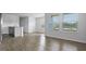 Bright living room boasts wood-look floors and an abundance of natural light through large windows at 119 Mims Academy Dr, Harleyville, SC 29448