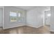 Spacious living room showcasing wood-look floors and ample natural light at 119 Mims Academy Dr, Harleyville, SC 29448