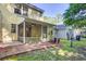View of the backyard with brick patio and screened-in porch at 1201 Pine Bluff Dr, Summerville, SC 29483