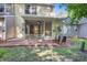 Back of yellow house with screened-in porch, patio, and grassy yard at 1201 Pine Bluff Dr, Summerville, SC 29483