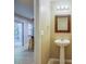 Small bathroom with pedestal sink, decorative mirror, and recessed lighting is conveniently located near the kitchen at 1201 Pine Bluff Dr, Summerville, SC 29483