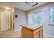 The kitchen offers an island countertop and a sliding door that leads to the exterior space and sunlight at 1201 Pine Bluff Dr, Summerville, SC 29483