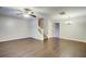 Spacious living room with hardwood floors, ceiling fan, staircase, and ample natural light at 1201 Pine Bluff Dr, Summerville, SC 29483