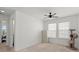 Spacious bedroom featuring neutral carpet, a ceiling fan, and ample natural light from the windows at 127 Longford Dr, Summerville, SC 29483