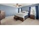 Comfortable bedroom with an upholstered stool at the foot of a beautiful wood bed and matching furniture at 127 Longford Dr, Summerville, SC 29483
