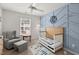 A cozy Bedroom is decorated with a light blue accent wall, matching decor and stylish furniture at 127 Longford Dr, Summerville, SC 29483