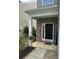 Covered entrance to home with brick accents, featuring a welcome sign and a black front door at 127 Longford Dr, Summerville, SC 29483