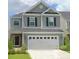 Charming two-story home featuring gray siding, black shutters, and a two-car garage at 127 Longford Dr, Summerville, SC 29483