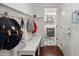 Functional mudroom area equipped with hooks, a bench, and storage, leading to the powder room at 127 Longford Dr, Summerville, SC 29483