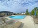 Community pool with lounge chairs, umbrellas, and a nearby playground for residents' enjoyment at 127 Longford Dr, Summerville, SC 29483