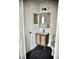 Modern bathroom features a vanity with wood and wicker doors, a mirror, and dark hexagon tile flooring at 1341 Pinnacle Ln, Charleston, SC 29412