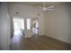 Open-concept living room flowing into the kitchen, featuring light wood floors and a ceiling fan at 1341 Pinnacle Ln, Charleston, SC 29412