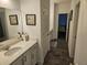 Bathroom with a vanity, stone countertop, mirror, and wood-look flooring at 1495 Keshi Pearl Dr, Mount Pleasant, SC 29466