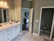 Bathroom with double vanity and tiled floors, adjacent to bedroom and toilet room at 1495 Keshi Pearl Dr, Mount Pleasant, SC 29466