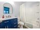 Well-lit bathroom with a blue vanity, a modern mirror, and a shower-tub combination at 1495 Keshi Pearl Dr, Mount Pleasant, SC 29466