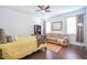 Bedroom with a bed, a sofa, dark wood floors and natural light from the windows at 1495 Keshi Pearl Dr, Mount Pleasant, SC 29466