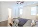 Well-lit bedroom with dark wood floors, a ceiling fan, and a view into the ensuite bathroom at 1495 Keshi Pearl Dr, Mount Pleasant, SC 29466