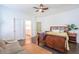 Bedroom featuring a bed, a sofa, dark wood floors, and an open door to the bathroom at 1495 Keshi Pearl Dr, Mount Pleasant, SC 29466
