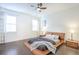 Bright bedroom with a platform bed, dark wood floors, ceiling fan, and windows with curtains at 1495 Keshi Pearl Dr, Mount Pleasant, SC 29466