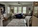 Bright bedroom with multiple windows, ceiling fan, hardwood floors, and unique decor at 1495 Keshi Pearl Dr, Mount Pleasant, SC 29466