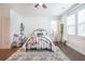 Sunlit bedroom featuring hardwood floors, a cozy rug, and a unique hanging hammock chair at 1495 Keshi Pearl Dr, Mount Pleasant, SC 29466