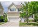 Charming two-story home with a well-manicured lawn and a two-car garage at 1495 Keshi Pearl Dr, Mount Pleasant, SC 29466