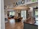 Open-concept kitchen and living area with a large kitchen island, stainless steel appliances, and hardwood flooring at 1495 Keshi Pearl Dr, Mount Pleasant, SC 29466