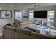 Bright living room with large windows, hardwood floors, and a comfortable sectional sofa, featuring modern decor at 1495 Keshi Pearl Dr, Mount Pleasant, SC 29466