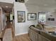 Comfortable living room with hardwood floors and beach themed artwork with a neutral colored sectional sofa at 1495 Keshi Pearl Dr, Mount Pleasant, SC 29466
