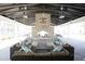 Cozy outdoor lounge area with comfortable seating and a brick fireplace at 1495 Keshi Pearl Dr, Mount Pleasant, SC 29466