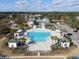 Aerial view of a community pool with cabanas and palm trees, surrounded by a residential area at 1495 Keshi Pearl Dr, Mount Pleasant, SC 29466