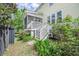 Charming screened porch with white railings and steps leading to the garden, perfect for outdoor relaxation at 1495 Keshi Pearl Dr, Mount Pleasant, SC 29466