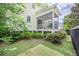 Cozy screened porch with ceiling fan and outdoor seating, providing a relaxing view of the landscaped yard at 1495 Keshi Pearl Dr, Mount Pleasant, SC 29466