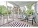 Relaxing screened porch featuring cozy seating and a stylish black and white striped rug at 1495 Keshi Pearl Dr, Mount Pleasant, SC 29466
