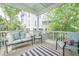 Relaxing screened porch featuring cozy seating and a stylish black and white striped rug at 1495 Keshi Pearl Dr, Mount Pleasant, SC 29466