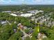 An aerial view of a residential neighborhood near Charleston, surrounded by mature trees and a serene pond at 1514 Village Sq, Mount Pleasant, SC 29464