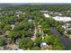 An aerial view of a residential neighborhood near Old Mt Pleasant, surrounded by mature trees and a serene pond at 1514 Village Sq, Mount Pleasant, SC 29464