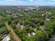 An aerial view of a residential area with mature trees and a serene pond in a quiet neighborhood by the water at 1514 Village Sq, Mount Pleasant, SC 29464