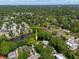 An aerial view of a home surrounded by lush trees and a serene pond in a quiet neighborhood at 1514 Village Sq, Mount Pleasant, SC 29464