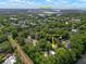 An aerial view of a residential neighborhood near Sullivans Island, surrounded by mature trees and a serene pond at 1514 Village Sq, Mount Pleasant, SC 29464