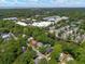 An aerial view of a residential neighborhood near Charleston, surrounded by mature trees and a serene pond at 1514 Village Sq, Mount Pleasant, SC 29464