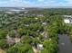 An aerial view of a residential area with mature trees and a serene pond in a quiet neighborhood by the water at 1514 Village Sq, Mount Pleasant, SC 29464