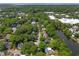 An aerial view of a residential area surrounded by lush mature trees and a serene pond in a quiet neighborhood at 1514 Village Sq, Mount Pleasant, SC 29464